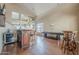 Open living space featuring hardwood floors, a bar, pool table, and natural light at 4864 E Eden Dr, Cave Creek, AZ 85331