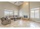 Bright living room featuring tile floors, a fireplace, and large windows, creating a spacious atmosphere at 4864 E Eden Dr, Cave Creek, AZ 85331