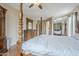 Spacious bedroom with a four poster bed, wood floors, mirrored closets and ceiling fan at 4864 E Eden Dr, Cave Creek, AZ 85331