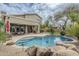 Inviting private pool and back patio, surrounded by desert landscaping and decorative rocks at 4864 E Eden Dr, Cave Creek, AZ 85331
