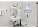 Modern bathroom featuring marble tile shower with glass door, window and quartz countertop sink at 5036 N Scottsdale Rd, Paradise Valley, AZ 85253