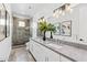 Spacious bathroom with double vanity, quartz countertops, modern lighting and walk-in shower at 5036 N Scottsdale Rd, Paradise Valley, AZ 85253