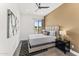 Bedroom featuring a queen bed, ceiling fan, modern art, and a large window at 5036 N Scottsdale Rd, Paradise Valley, AZ 85253
