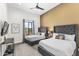 Bright bedroom featuring two beds with grey headboards, a ceiling fan and large window at 5036 N Scottsdale Rd, Paradise Valley, AZ 85253