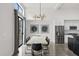 Dining area with modern lighting and stainless steel refrigerator, complemented by unique artwork at 5036 N Scottsdale Rd, Paradise Valley, AZ 85253