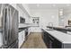 Stylish kitchen with white cabinets, black countertops, stainless steel appliances, and a modern design at 5036 N Scottsdale Rd, Paradise Valley, AZ 85253