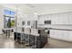 Bright, modern kitchen with a large center island, sleek white cabinets, and stainless steel appliances at 5036 N Scottsdale Rd, Paradise Valley, AZ 85253