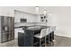 Modern kitchen features a large waterfall island with seating and sleek stainless steel appliances at 5036 N Scottsdale Rd, Paradise Valley, AZ 85253