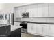 Bright kitchen with stainless steel appliances, white cabinets, and contrasting countertops at 5036 N Scottsdale Rd, Paradise Valley, AZ 85253