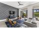 Contemporary living space featuring a decorative wall, stylish seating, and access to a patio at 5036 N Scottsdale Rd, Paradise Valley, AZ 85253