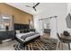 Main bedroom features a dark accent wall, modern decor, ceiling fan and sliding bathroom doors at 5036 N Scottsdale Rd, Paradise Valley, AZ 85253