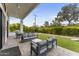 Spacious outdoor patio with comfortable seating, a dining area, and a well-maintained lawn at 5036 N Scottsdale Rd, Paradise Valley, AZ 85253