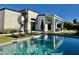 Inviting backyard oasis featuring a sparkling pool, lounge chairs, and a modern home with a spiral staircase at 5036 N Scottsdale Rd, Paradise Valley, AZ 85253