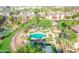 Aerial view of a sparkling community pool, hot tub, and lush tropical landscaping at 5401 E Van Buren St # 3113, Phoenix, AZ 85008