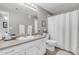 Bathroom with white vanity, toilet, and shower curtain, showcasing a clean design at 5401 E Van Buren St # 3113, Phoenix, AZ 85008