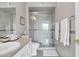 Bathroom with a glass-enclosed shower, vanity, and toilet, showcasing a clean design at 5401 E Van Buren St # 3113, Phoenix, AZ 85008