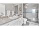 Bathroom with a glass-enclosed shower, vanity, and toilet, showcasing a clean design at 5401 E Van Buren St # 3113, Phoenix, AZ 85008