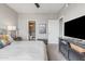 Bedroom with a large bed, nightstands, TV, and ensuite bathroom for added privacy and convenience at 5401 E Van Buren St # 3113, Phoenix, AZ 85008