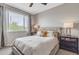 Neutral bedroom with a large window, ceiling fan, and comfortable furnishings at 5401 E Van Buren St # 3113, Phoenix, AZ 85008
