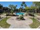 Landscaped community pool area surrounded by mature trees and lounge chairs at 5401 E Van Buren St # 3113, Phoenix, AZ 85008
