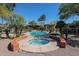 Relaxing community pool and spa surrounded by landscaped grounds and palm trees at 5401 E Van Buren St # 3113, Phoenix, AZ 85008