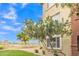 Exterior view of a well-maintained apartment building with blue skies and manicured grounds at 5401 E Van Buren St # 3113, Phoenix, AZ 85008