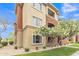 Beautiful condo building with well-maintained landscaping, flowering tree, and lush green grass at 5401 E Van Buren St # 3113, Phoenix, AZ 85008