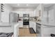 Bright kitchen featuring white cabinets, granite countertops, and stainless steel appliances at 5401 E Van Buren St # 3113, Phoenix, AZ 85008