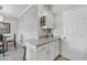 Kitchenette includes granite counters, white cabinets, wine rack and breakfast bar at 5401 E Van Buren St # 3113, Phoenix, AZ 85008