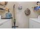 Practical laundry room with shelving for storage and a utility sink at 5401 E Van Buren St # 3113, Phoenix, AZ 85008