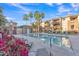 Beautiful community pool with palm trees, lounge chairs and well-maintained landscaping at 5401 E Van Buren St # 3113, Phoenix, AZ 85008