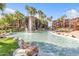Beautiful water feature with fountains, surrounded by palm trees and lush greenery within the community at 5401 E Van Buren St # 3113, Phoenix, AZ 85008
