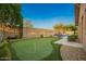 Lush backyard featuring a putting green, pool, and desert landscaping at 5528 W Mine Trl, Phoenix, AZ 85083
