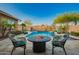 Beautiful backyard with a pool, waterfall, and fire pit seating area at 5528 W Mine Trl, Phoenix, AZ 85083