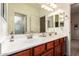 Bright bathroom with double sinks and vanity, blending practicality with charm, adding functional elegance at 5528 W Mine Trl, Phoenix, AZ 85083