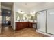 Bright bathroom with double sinks, vanity space, and a large walk-in shower, offering both style and comfort at 5528 W Mine Trl, Phoenix, AZ 85083