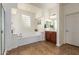 Bright bathroom with a soaking tub and a walk-in shower providing a spa-like experience at 5528 W Mine Trl, Phoenix, AZ 85083
