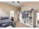 Comfortable bedroom with an extra bookcase creating a cozy place for relaxation and rest at 5528 W Mine Trl, Phoenix, AZ 85083