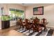 Elegant dining room with a large window, stylish rug, and a classic wooden table set for memorable gatherings at 5528 W Mine Trl, Phoenix, AZ 85083