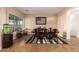 Elegant dining room with a large window, stylish rug, and a classic wooden table set for memorable gatherings at 5528 W Mine Trl, Phoenix, AZ 85083