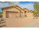 Stunning home with a spacious three-car garage and a well-maintained brick driveway, showcasing curb appeal at 5528 W Mine Trl, Phoenix, AZ 85083