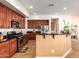 Open concept kitchen boasts stainless appliances, breakfast bar, granite countertops, and ample cabinetry at 5528 W Mine Trl, Phoenix, AZ 85083