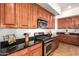 Modern kitchen featuring stainless steel appliances, granite countertops, and ample storage space for culinary enthusiasts at 5528 W Mine Trl, Phoenix, AZ 85083