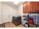Practical laundry room with a washer and dryer, storage cabinets, and tile flooring at 5528 W Mine Trl, Phoenix, AZ 85083