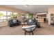 Inviting living room featuring large windows, comfortable seating, and an open layout for relaxation and entertainment at 5528 W Mine Trl, Phoenix, AZ 85083