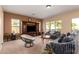 Spacious living room with an entertainment center, plush seating, and plenty of natural light creating a cozy atmosphere at 5528 W Mine Trl, Phoenix, AZ 85083