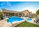 Backyard oasis featuring a sparkling pool, spa, lush greenery, and comfortable seating areas for outdoor relaxation at 5528 W Mine Trl, Phoenix, AZ 85083