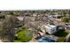 Aerial view featuring lush greenery, mature trees, and a tennis court at 7635 E Sweetwater Ave, Scottsdale, AZ 85260