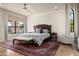 Spacious main bedroom featuring large windows, a ceiling fan, and an ornate rug at 7635 E Sweetwater Ave, Scottsdale, AZ 85260