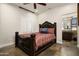 Bedroom with a decorative bed frame and access to an ensuite bathroom at 7635 E Sweetwater Ave, Scottsdale, AZ 85260